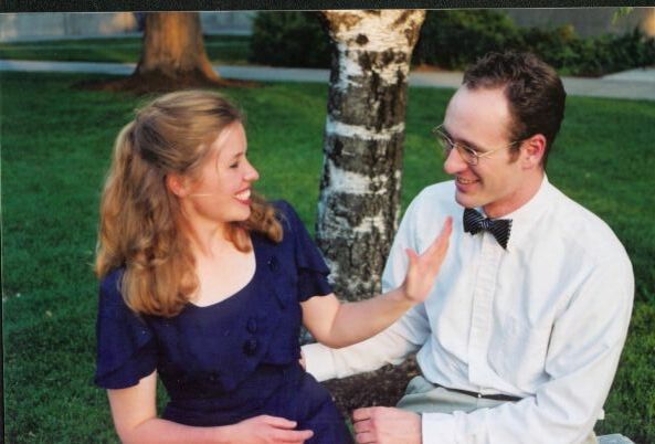 Catherine and Weston seated on bench facing each other, June 2001